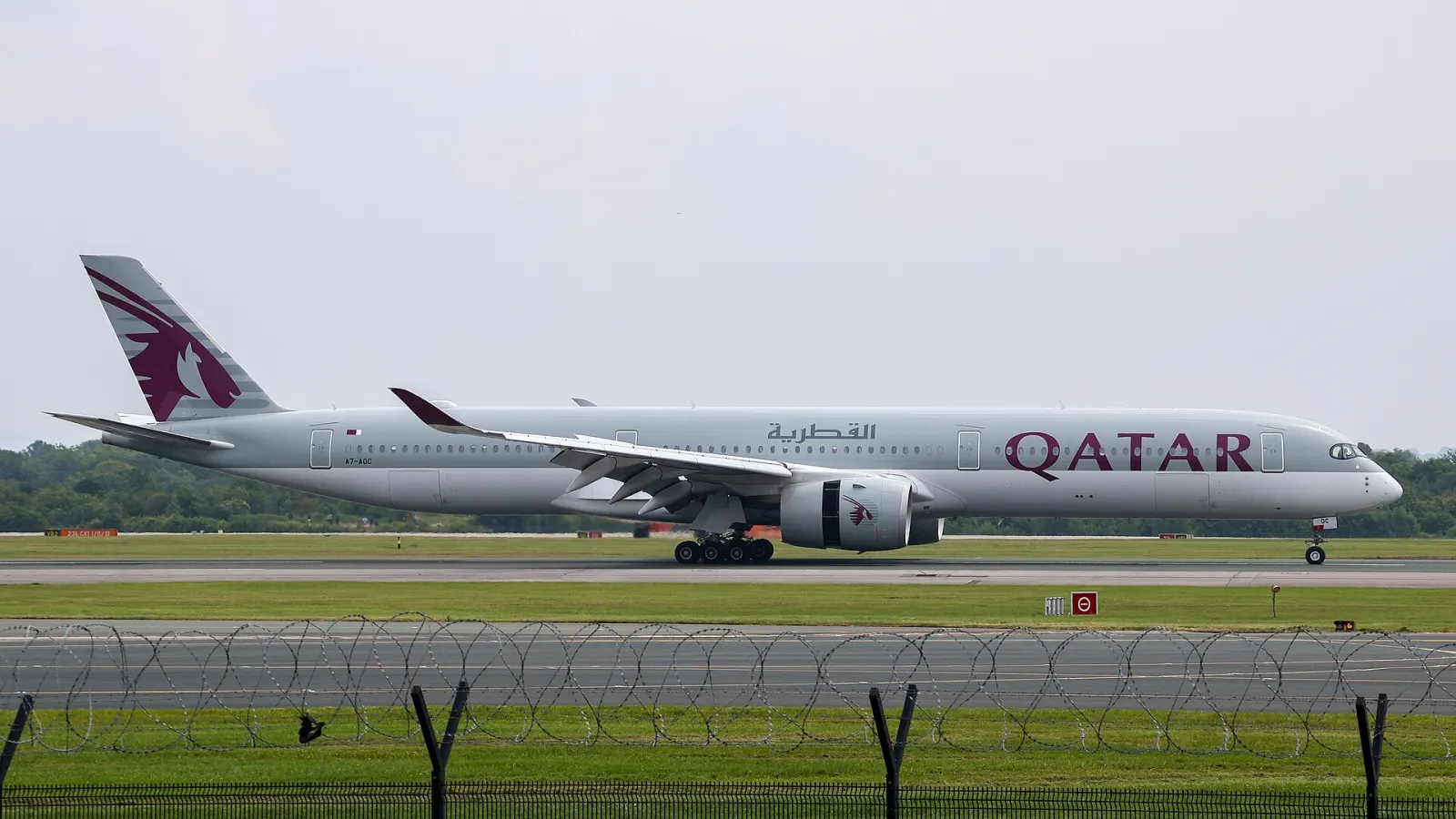 A Qatar Airways Airbus A350-1000 taxiing along a runway
